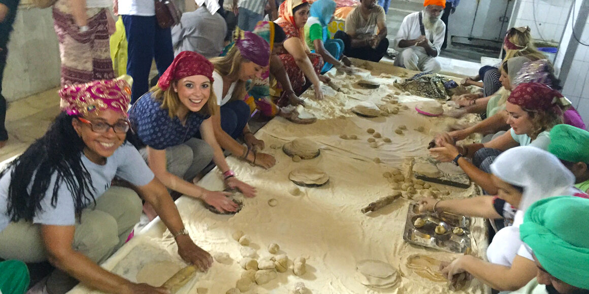 Volunteers rolling dough