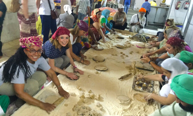Volunteers rolling dough